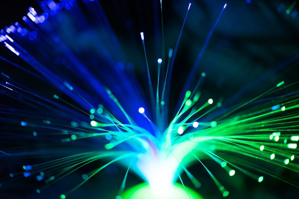 Close-up blue and green fiber-optic light paths